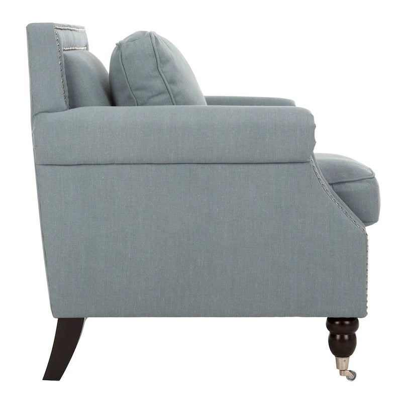 Sillón club clásico con reposabrazos enrollados y tachuelas